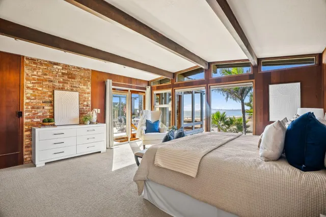 a bedroom with a bed and a painting on the wall