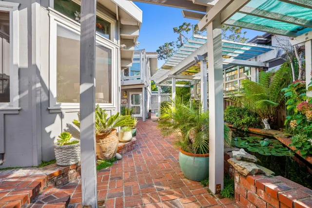 a front view of multiple houses with yard