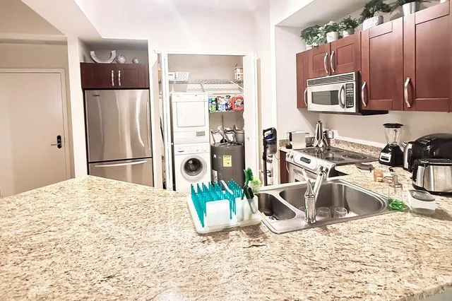 a kitchen with a refrigerator sink and microwave
