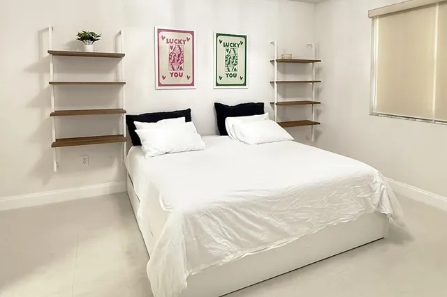 a large white bed in a white room