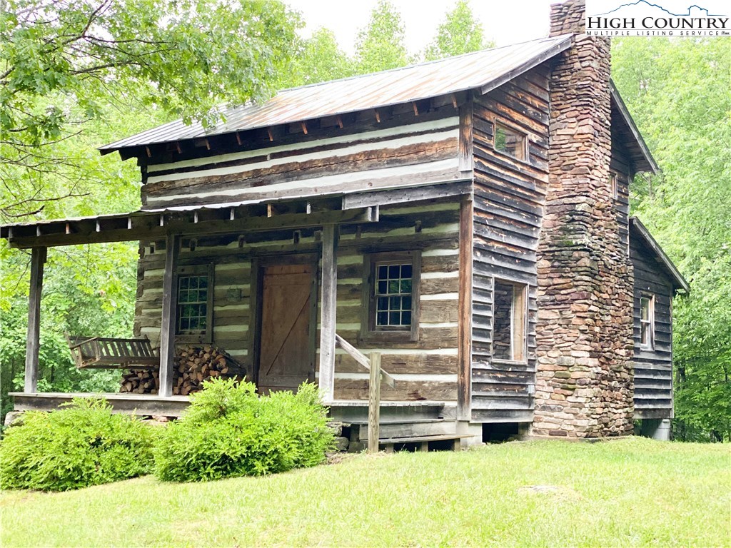 a view of house with backyard