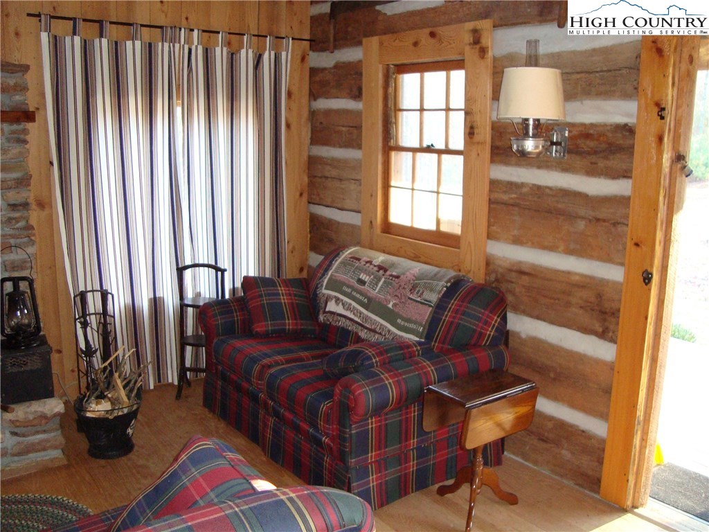 4360 Stones Chapel Road Elk Creek, VA 24326 - Photo 12 of 21 a living room with couches bookshelf and a large window