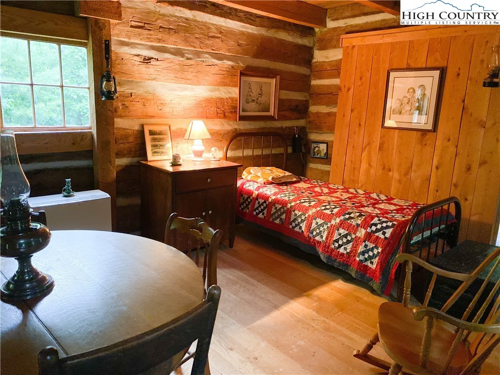 4360 Stones Chapel Road Elk Creek, VA 24326 - Photo 15 of 21 a bedroom with a bed and wooden floor