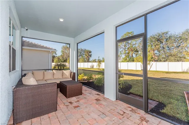 a living room with hardwood floor and a large window