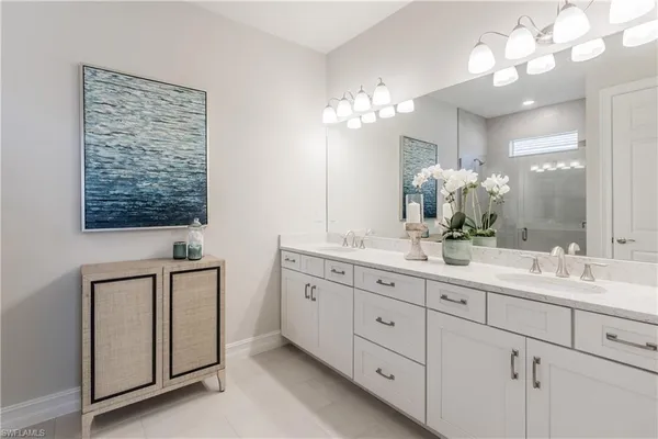 a bathroom with double sink and a mirror