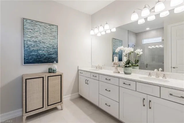 a bathroom with double sink and a mirror