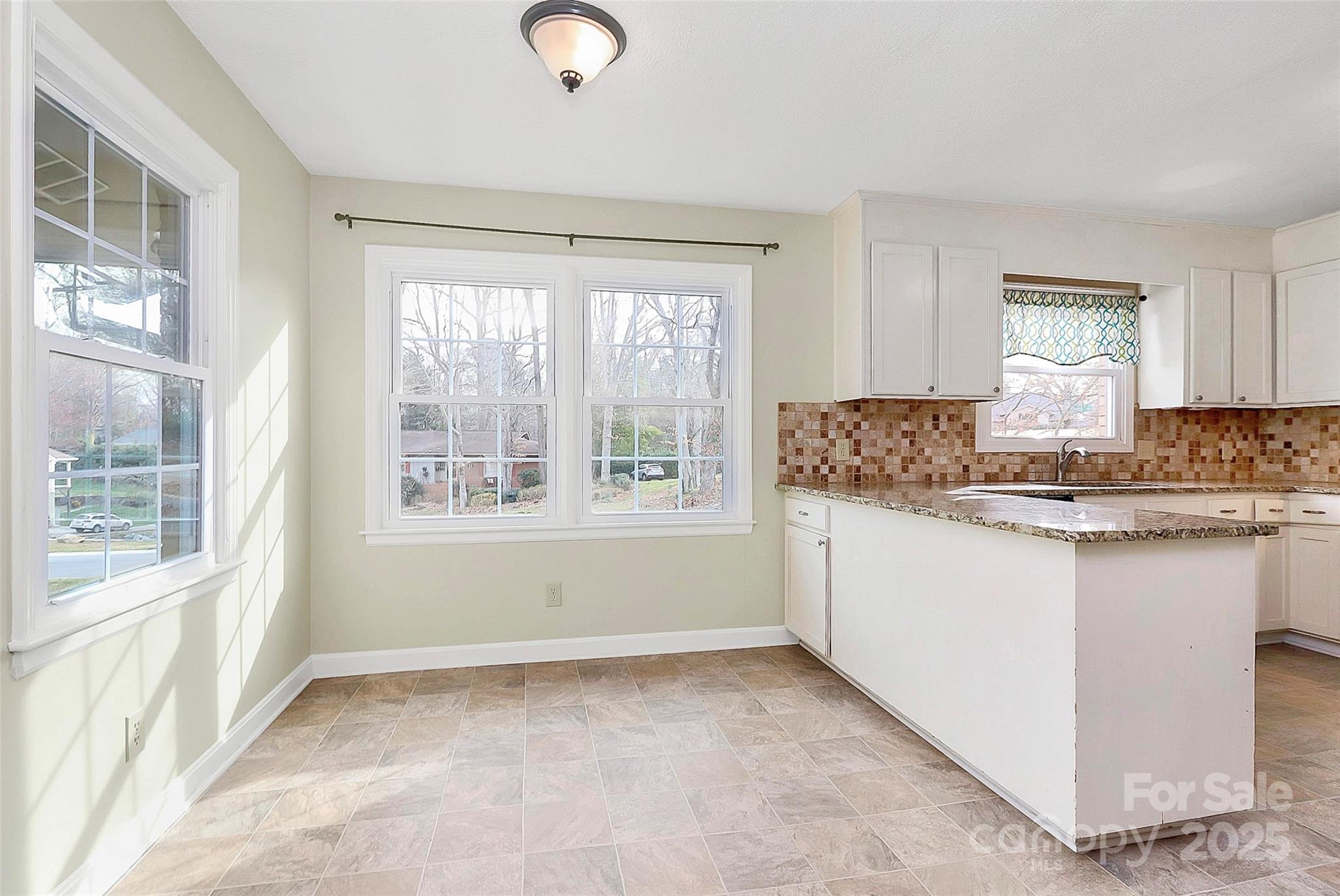 3200 Highview Road Charlotte, NC 28210 - Photo 13 of 48 a kitchen with granite countertop a stove a sink and a granite counter tops with white cabinets