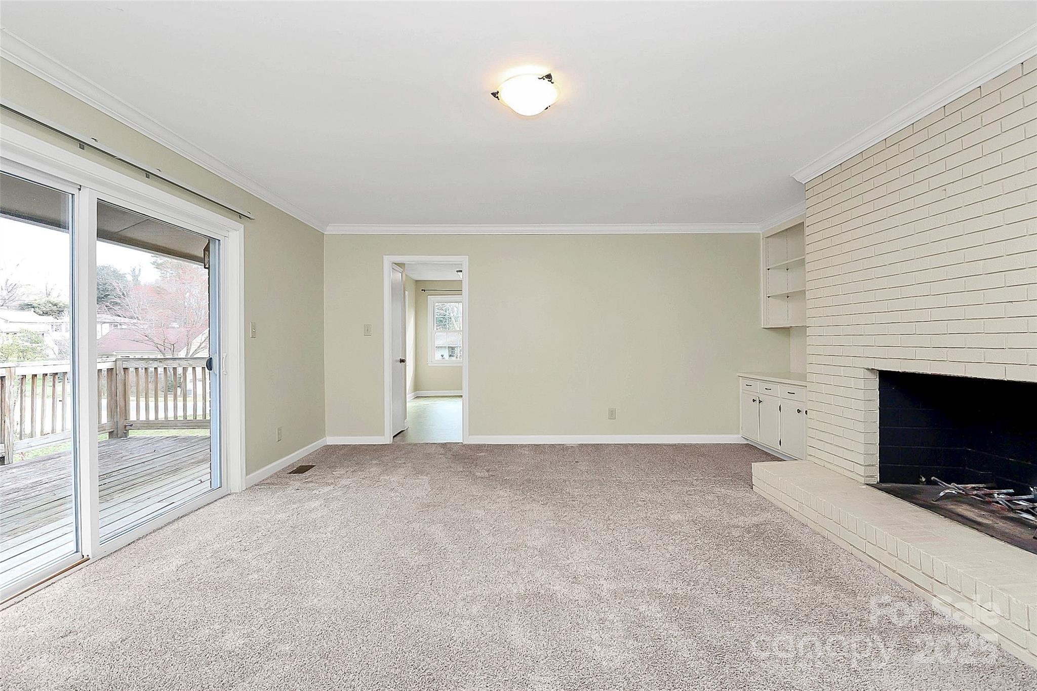 3200 Highview Road Charlotte, NC 28210 - Photo 16 of 48 en empty room with windows and fireplace