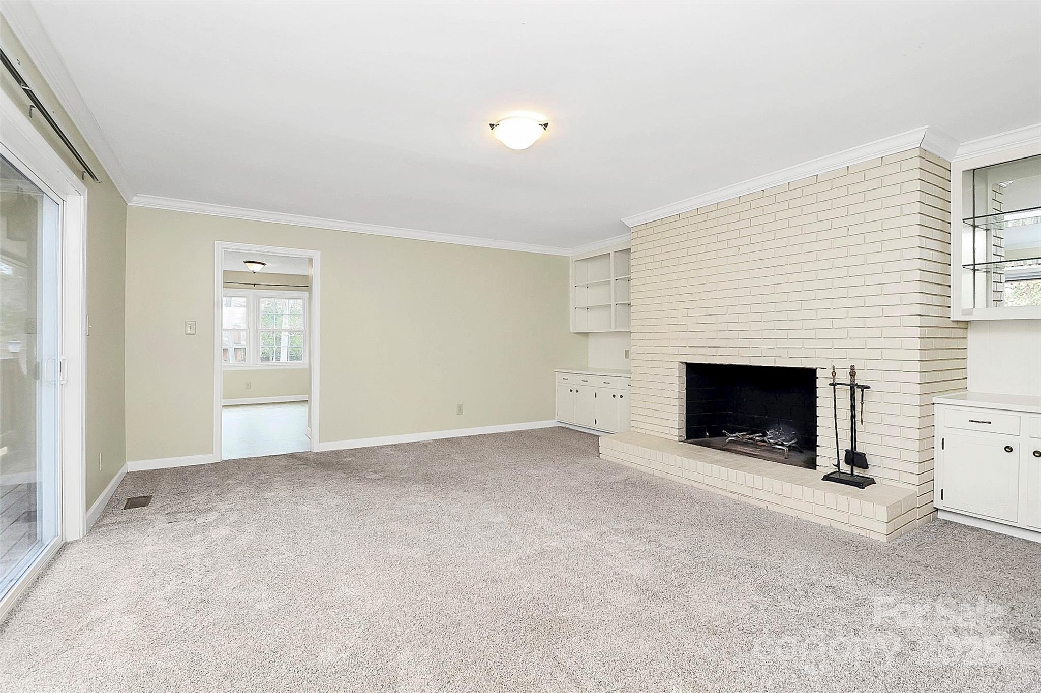 3200 Highview Road Charlotte, NC 28210 - Photo 17 of 48 a view of an empty room with a fireplace and a window