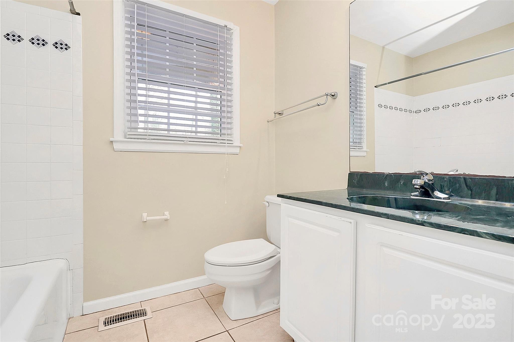 3200 Highview Road Charlotte, NC 28210 - Photo 19 of 48 a bathroom with a granite countertop sink a toilet and a mirror