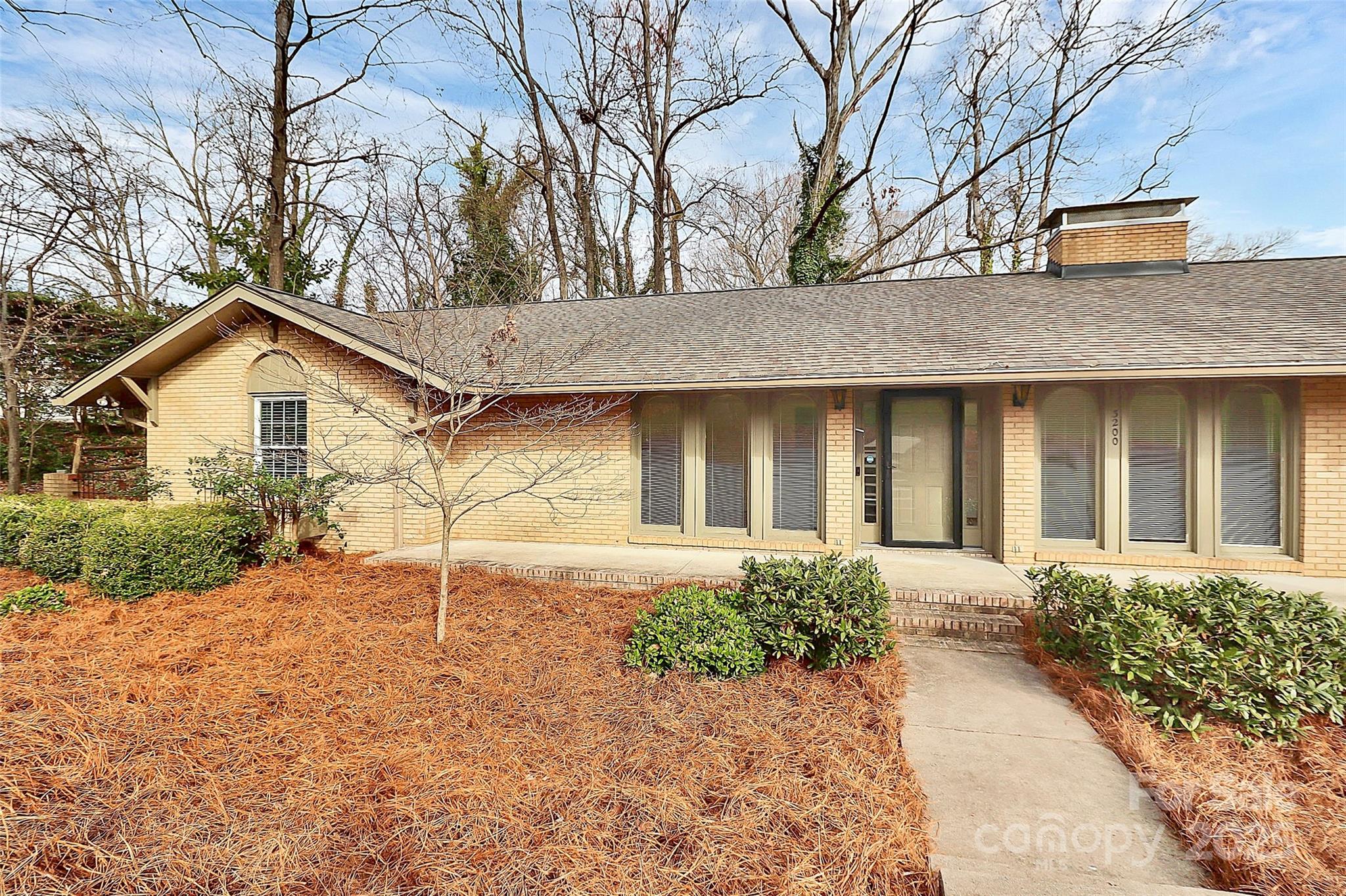 3200 Highview Road Charlotte, NC 28210 - Photo 2 of 48 a front view of a house with a yard and garage