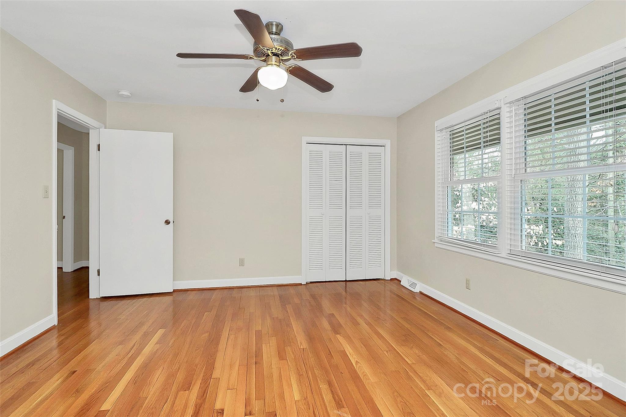 3200 Highview Road Charlotte, NC 28210 - Photo 22 of 48 an empty room with wooden floor fan and windows