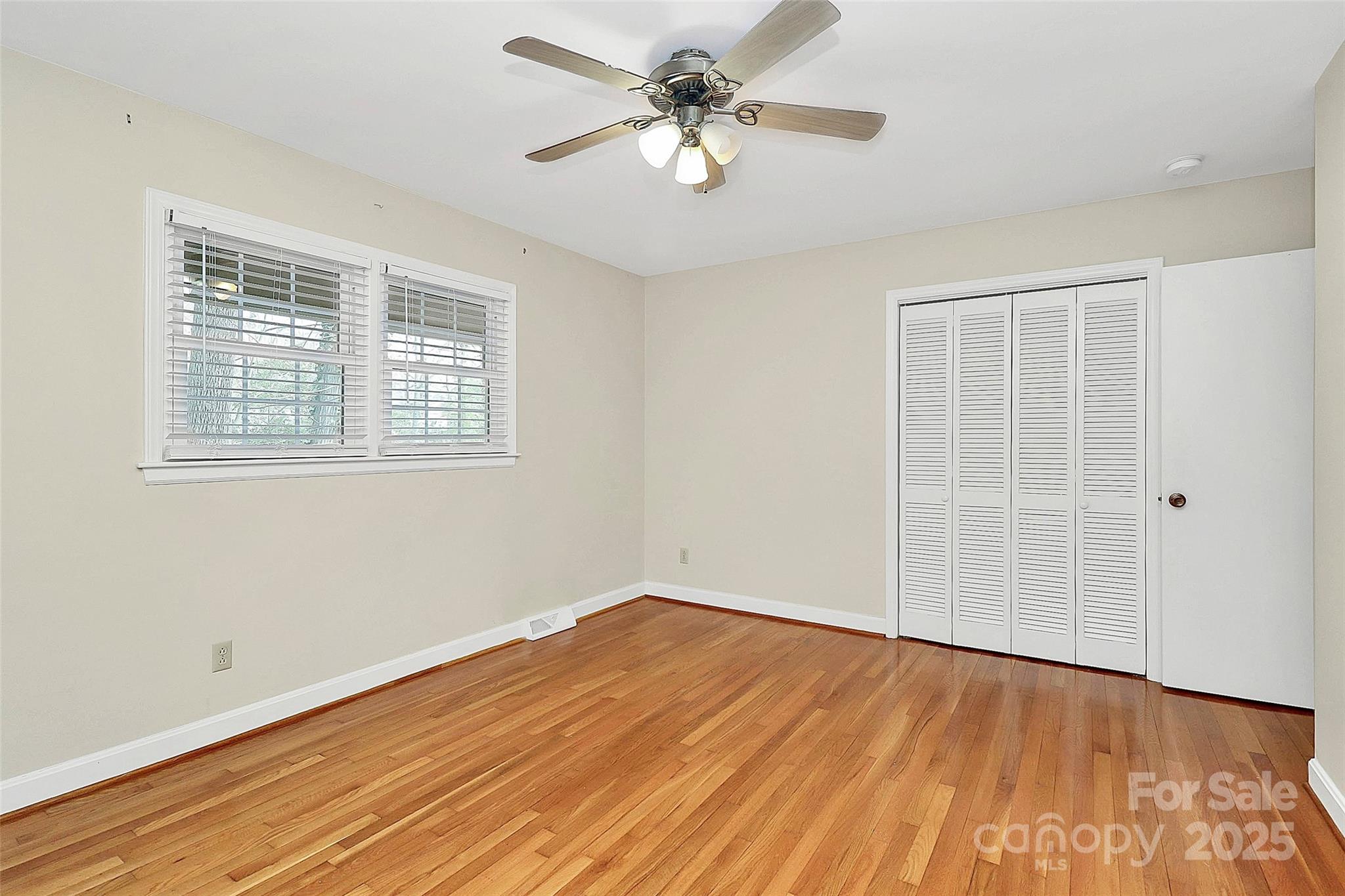 3200 Highview Road Charlotte, NC 28210 - Photo 23 of 48 a view of a room with wooden floor and a ceiling fan