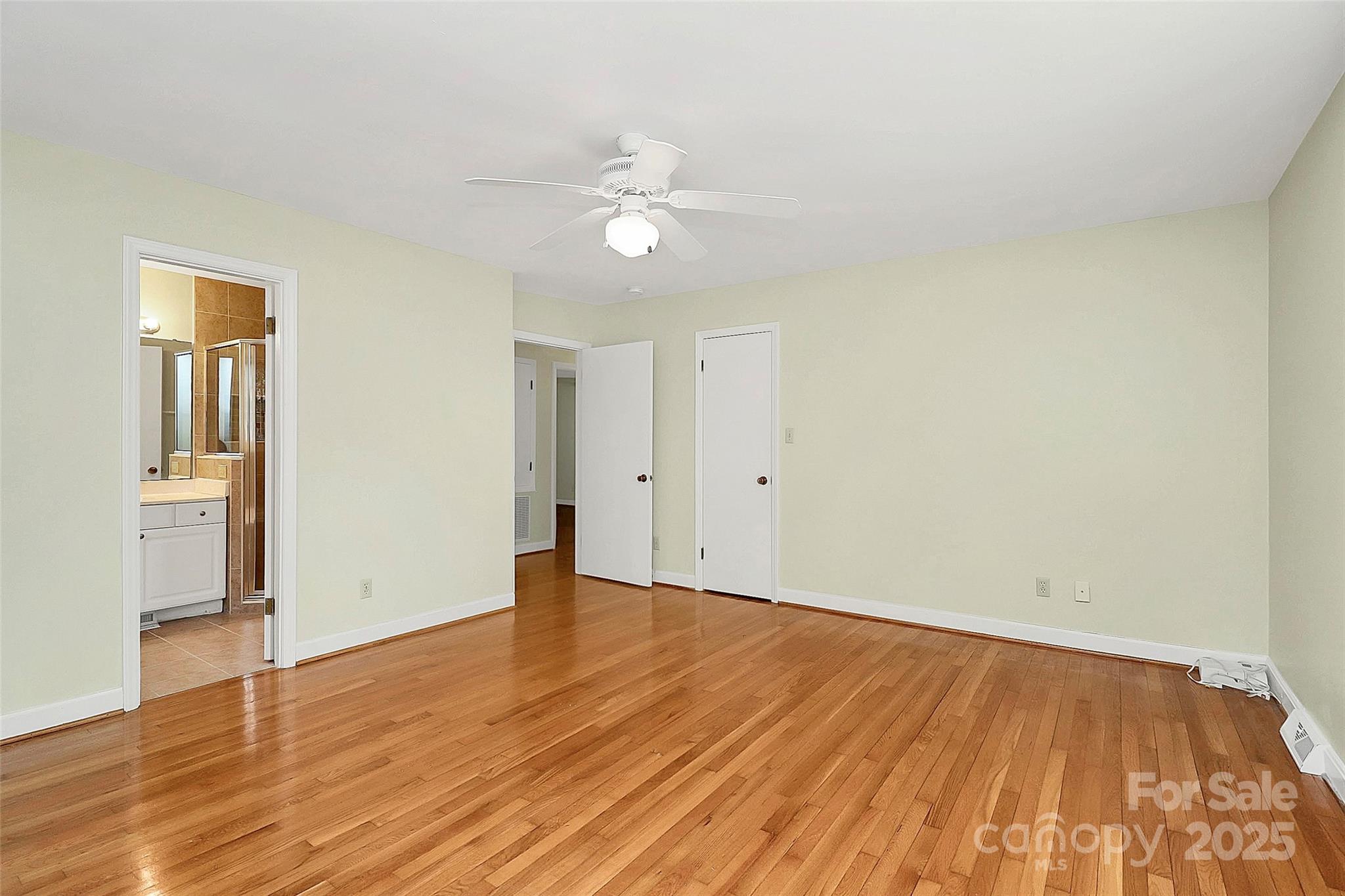 3200 Highview Road Charlotte, NC 28210 - Photo 25 of 48 a view of an empty room with wooden floor and a ceiling fan
