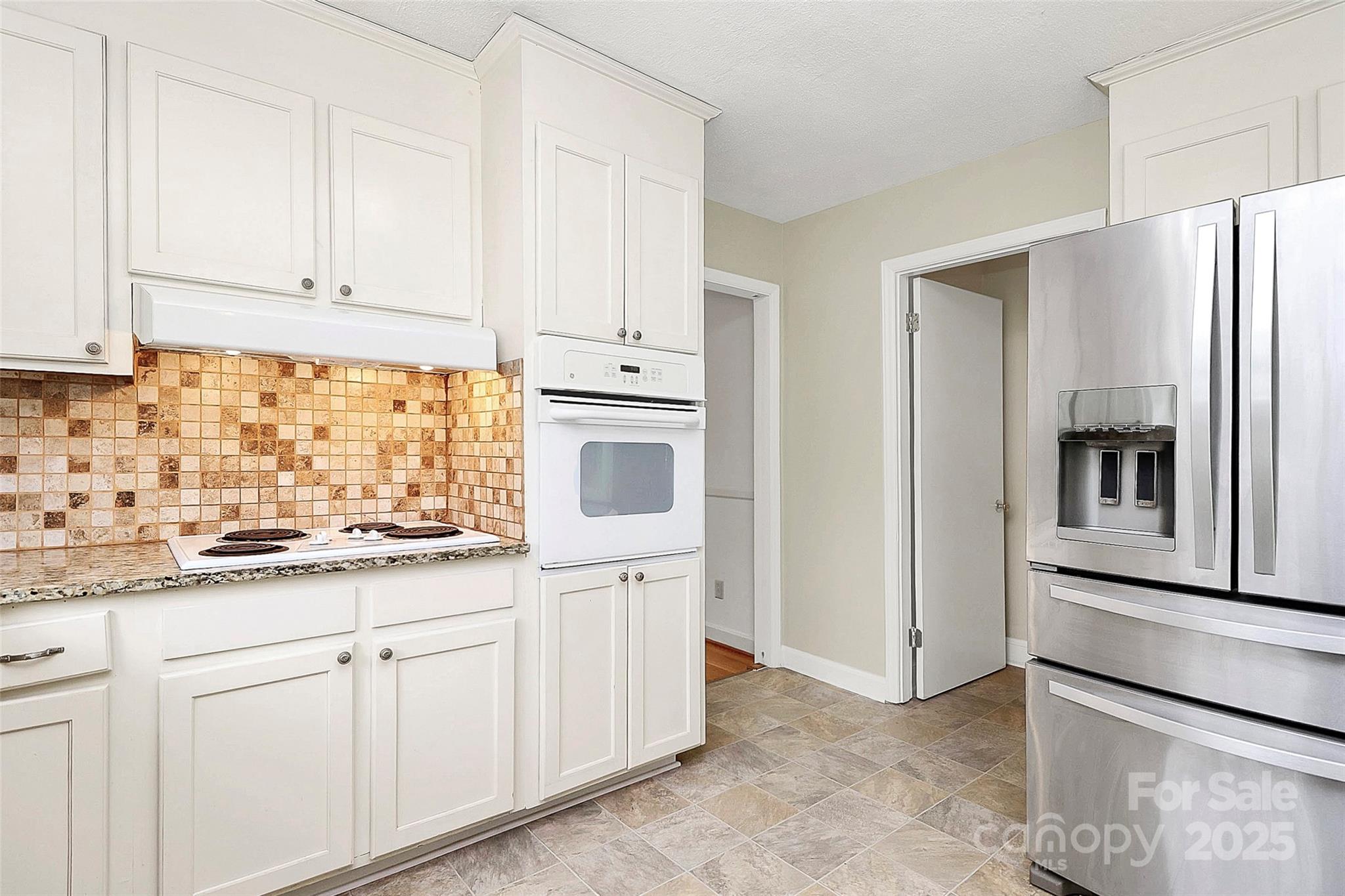 3200 Highview Road Charlotte, NC 28210 - Photo 10 of 48 a kitchen with white cabinets and sink