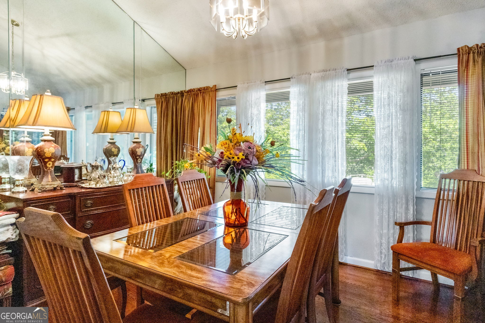 1509 High Point Road Bowdon, GA 30108 - Photo 11 of 33 a view of a dining room with furniture a chandelier and large windows