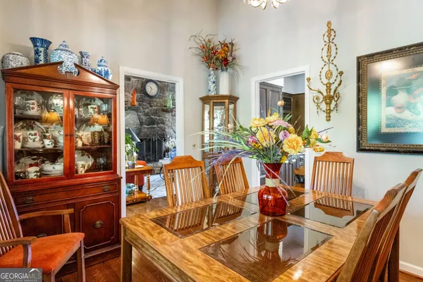 a view of a dining room with furniture a chandelier and wooden floor