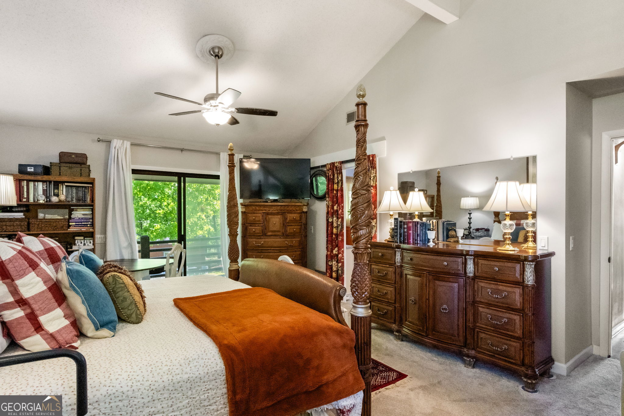 1509 High Point Road Bowdon, GA 30108 - Photo 17 of 33 a bedroom with a bed a chandelier and flat screen tv