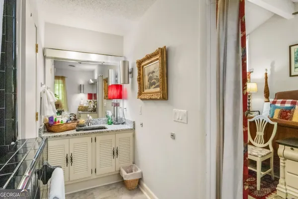 a bathroom with a sink vanity mirror and toilet