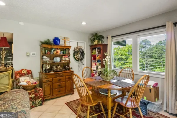 a living room with lots of furniture and potted plants