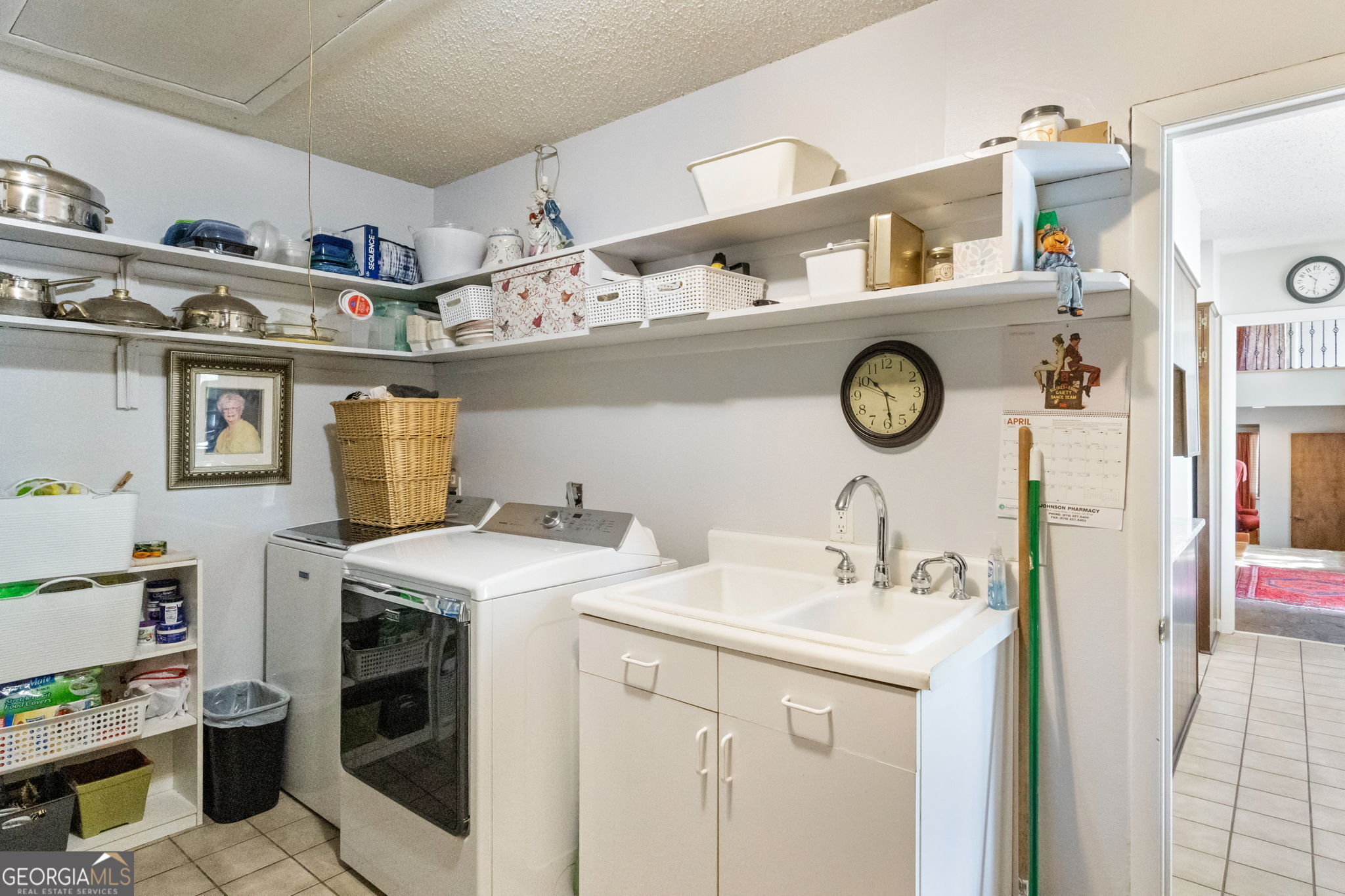 1509 High Point Road Bowdon, GA 30108 - Photo 29 of 33 a utility room with a sink a stove and cabinets