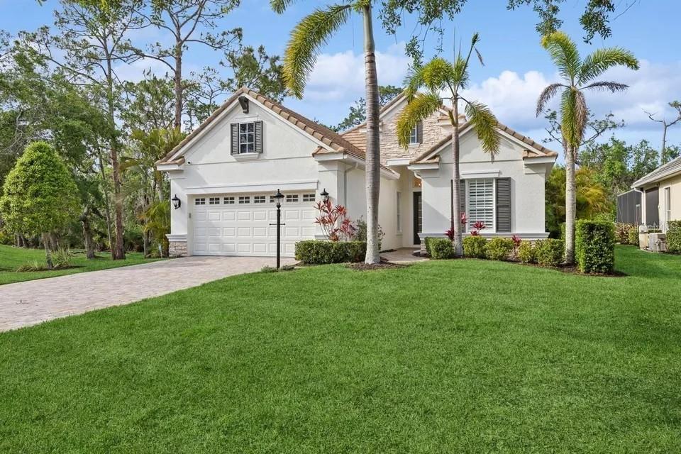 a front view of house with yard and green space