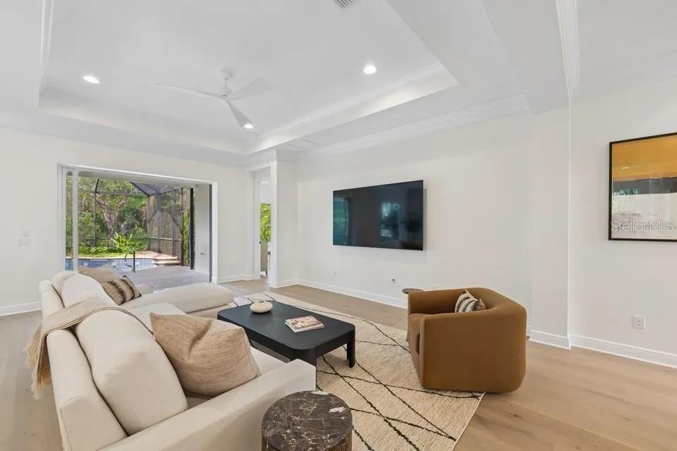 7346 Edenmore Street Lakewood Ranch, FL 34202 - Photo 11 of 70 a living room with furniture and a flat screen tv