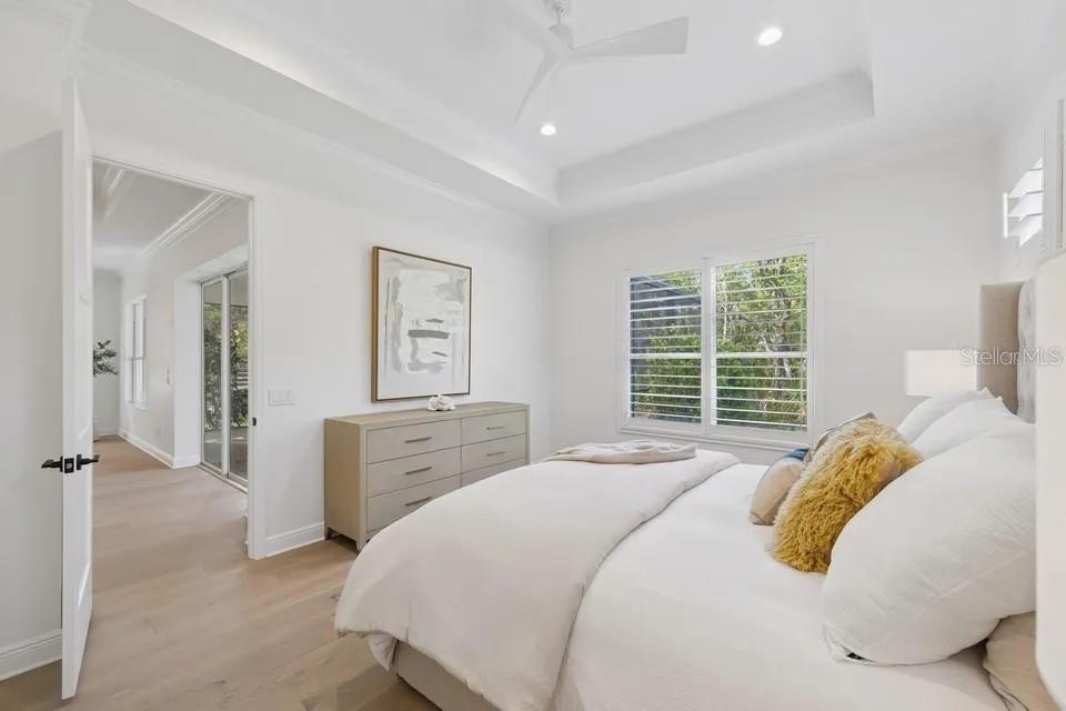 7346 Edenmore Street Lakewood Ranch, FL 34202 - Photo 31 of 70 a bedroom with a bed and wooden floor