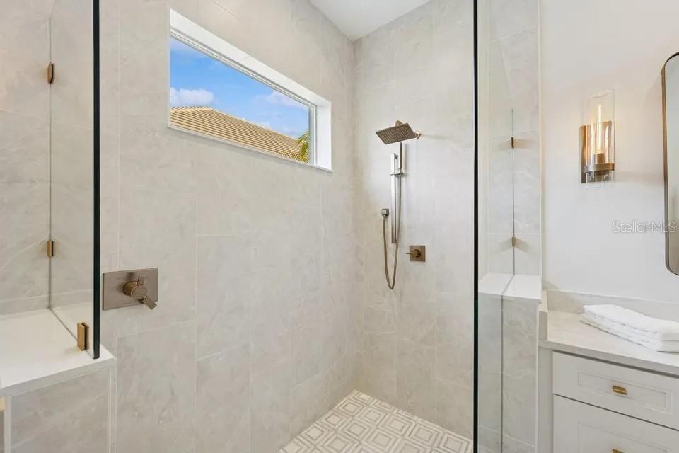 7346 Edenmore Street Lakewood Ranch, FL 34202 - Photo 32 of 70 a bathroom with a granite countertop shower mirror and a sink
