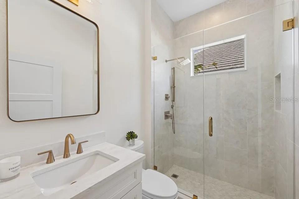 7346 Edenmore Street Lakewood Ranch, FL 34202 - Photo 36 of 70 a bathroom with a sink toilet and shower
