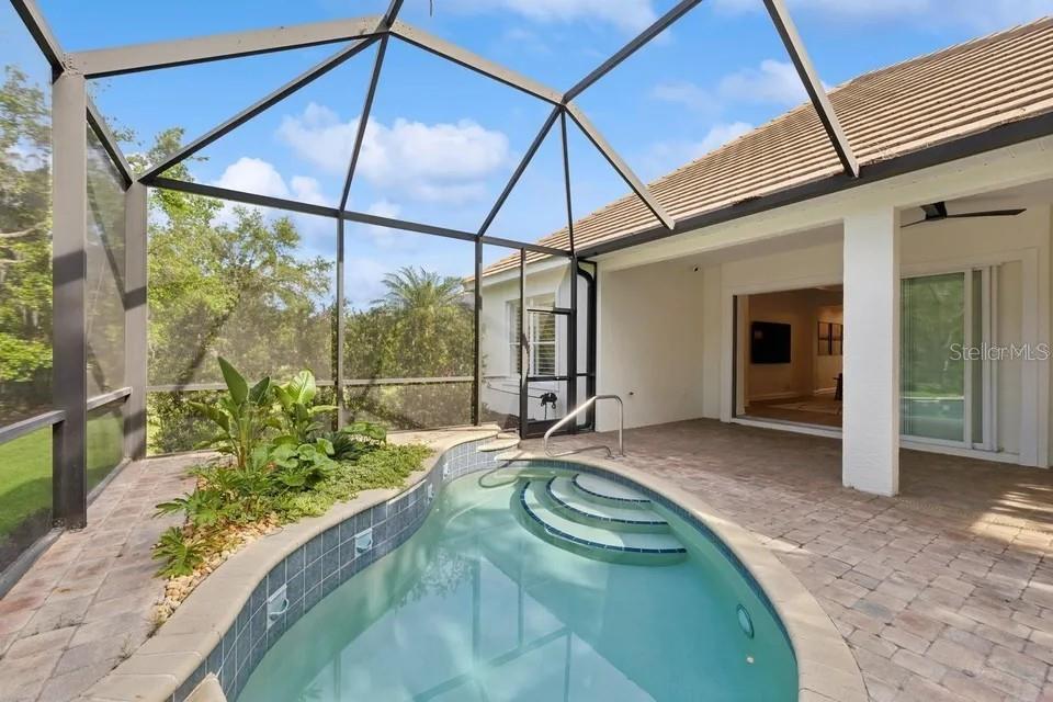 7346 Edenmore Street Lakewood Ranch, FL 34202 - Photo 39 of 70 a swimming pool with glass windows and yard