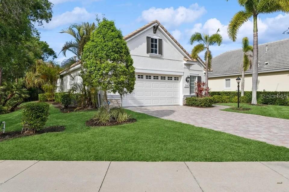7346 Edenmore Street Lakewood Ranch, FL 34202 - Photo 41 of 70 a front view of a house with a yard