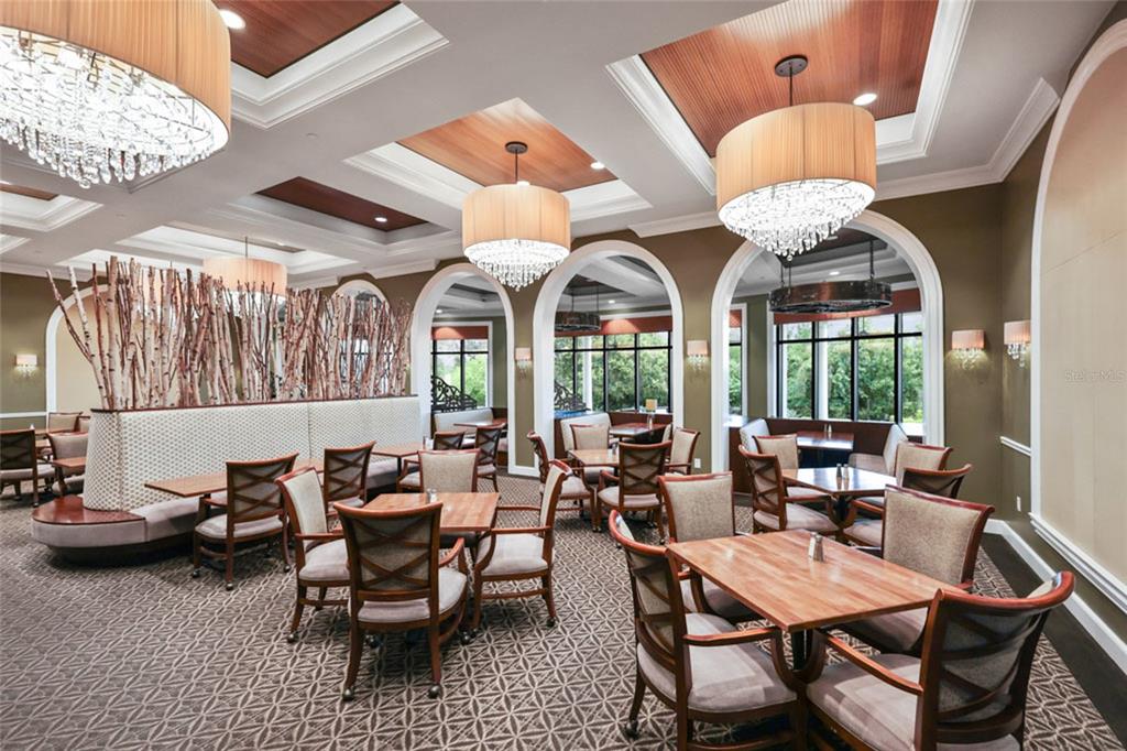 7346 Edenmore Street Lakewood Ranch, FL 34202 - Photo 59 of 70 a view of a dining room with furniture wooden floor and chandelier