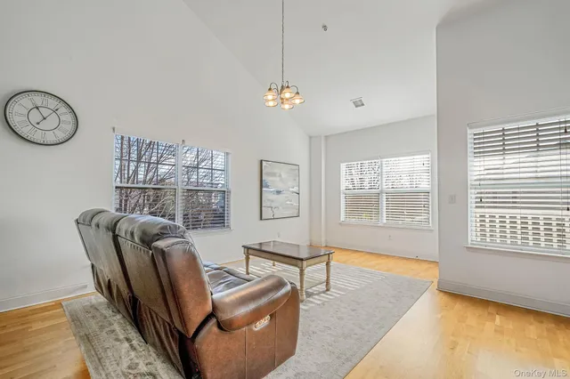 a living room with furniture a couch and a chandelier