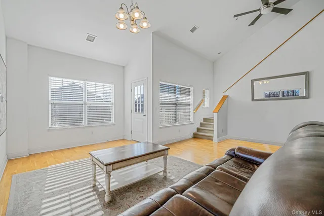 a spacious bedroom with a bed and wooden floor