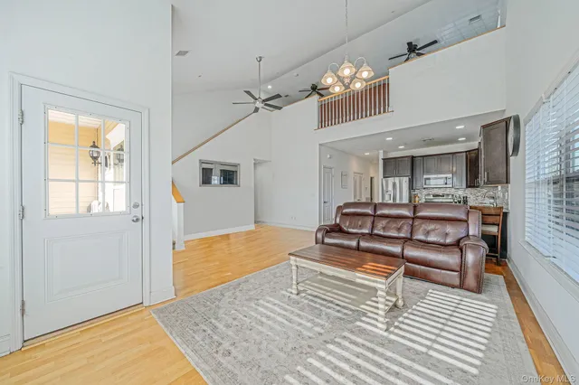 a bedroom with a bed chandelier and a window