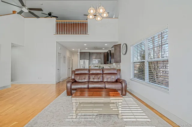 a kitchen with stainless steel appliances granite countertop a kitchen island hardwood floor and a sink