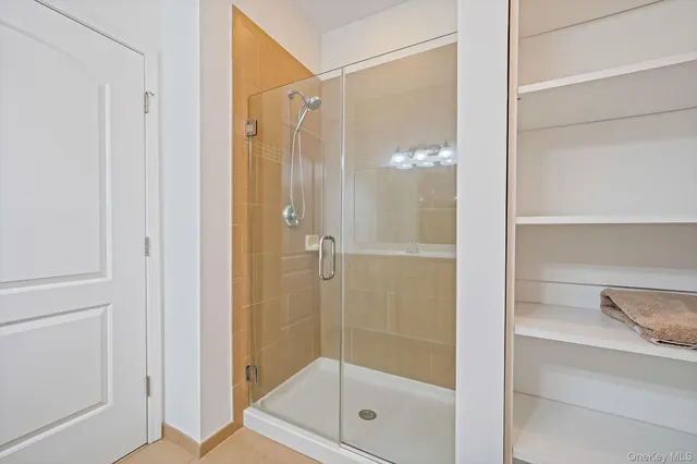 a bathroom with a glass shower door