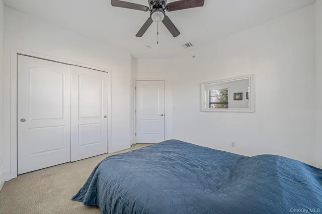 a bedroom with a bed and painting on the wall