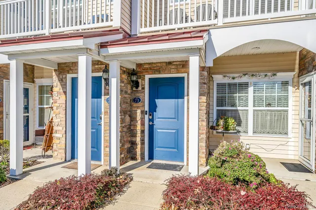 a view of a swimming pool with a chairs and table in the terrace