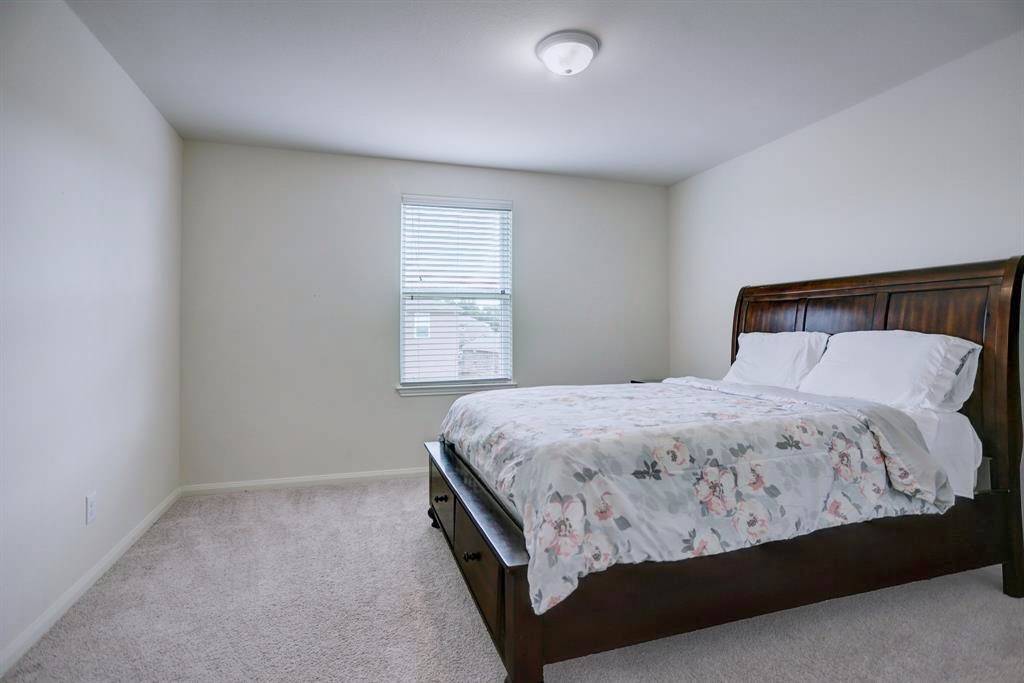 1303 Emerald Stone Drive Rosharon, TX 77583 - Photo 17 of 25 Bright and roomy upstairs bedroom designed for comfort and flexibility.