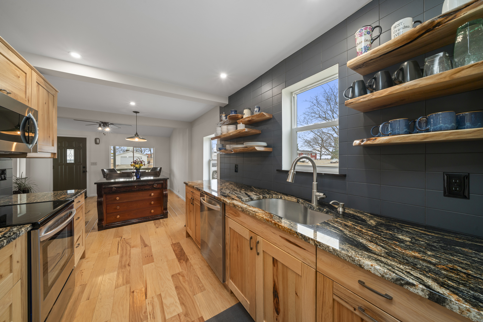 193 Chicago Road Paw Paw, IL 61353 - Photo 12 of 37 a kitchen with stainless steel appliances granite countertop a sink stove and cabinets