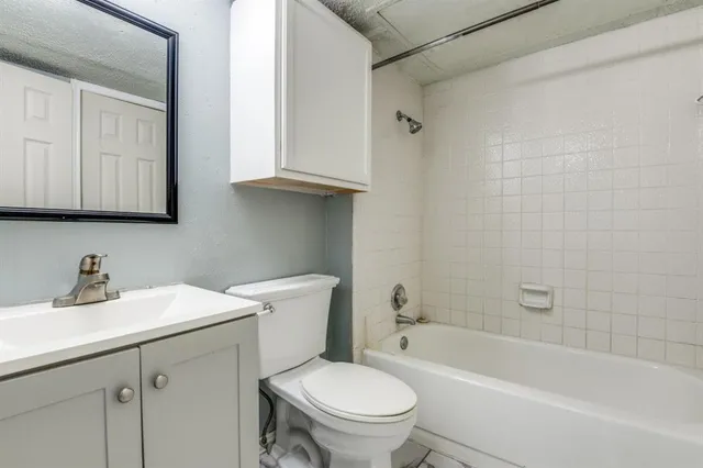 a bathroom with a sink a toilet and bathtub