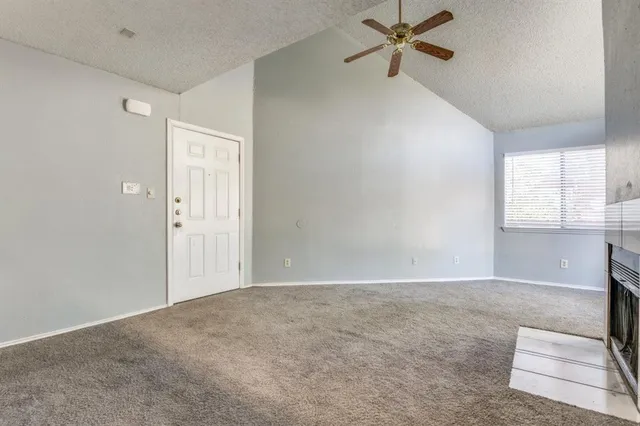 a view of a livingroom with a window and a ceiling fan