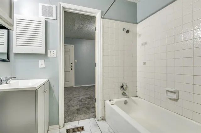 a bathroom with a bathtub and a sink