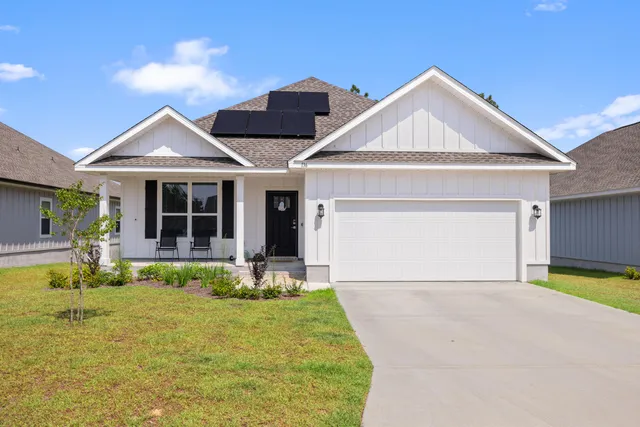 a front view of a house with yard and porch