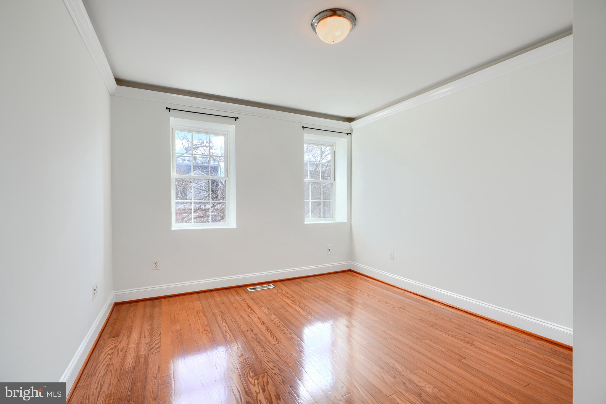 1520 Byrd Street Baltimore, MD 21230 - Photo 30 of 37 an empty room with wooden floor and windows