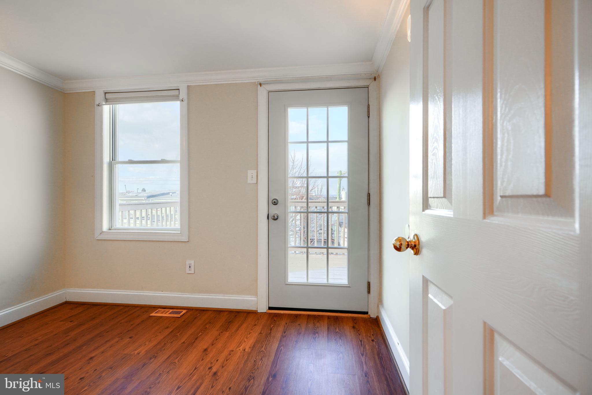 1520 Byrd Street Baltimore, MD 21230 - Photo 32 of 37 an empty room with wooden floor and windows