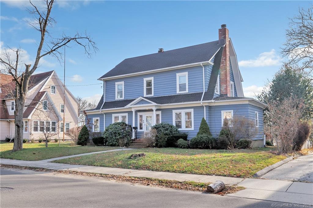 64 Hickory Street Bridgeport, CT 06610 - Photo 1 of 1 a front view of a house with a garden
