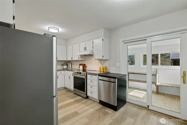 a kitchen with stainless steel appliances granite countertop a stove and a refrigerator